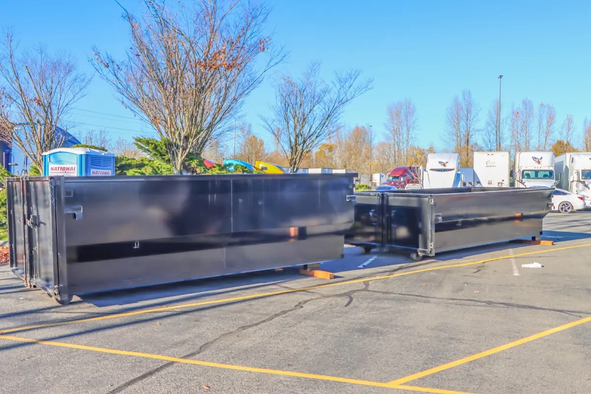 Professional dumpster rental service with roll-off container on residential driveway in Salem